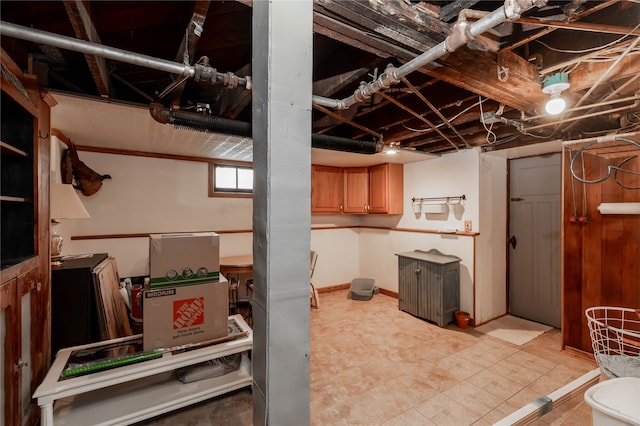 basement featuring light tile patterned floors