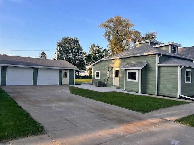 view of side of home featuring cooling unit and a yard