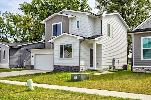 view of front of property featuring a garage, central air condition unit, and a front yard