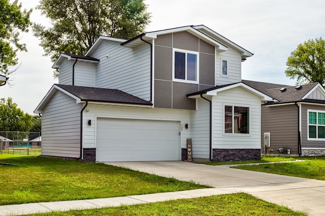 view of front of house with a garage and a front yard