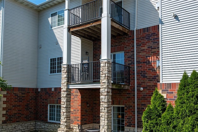 view of side of home with brick siding