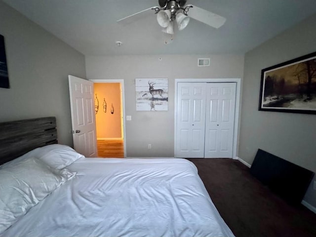 carpeted bedroom with ceiling fan, visible vents, and a closet