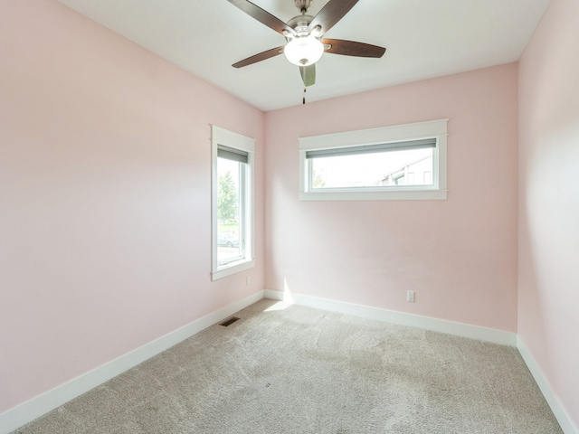 carpeted empty room featuring ceiling fan