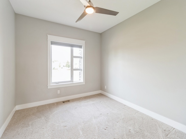 carpeted empty room with ceiling fan