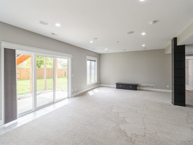 unfurnished living room featuring light carpet