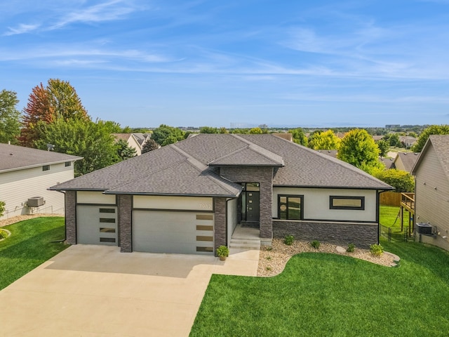 prairie-style home featuring a garage and a front yard