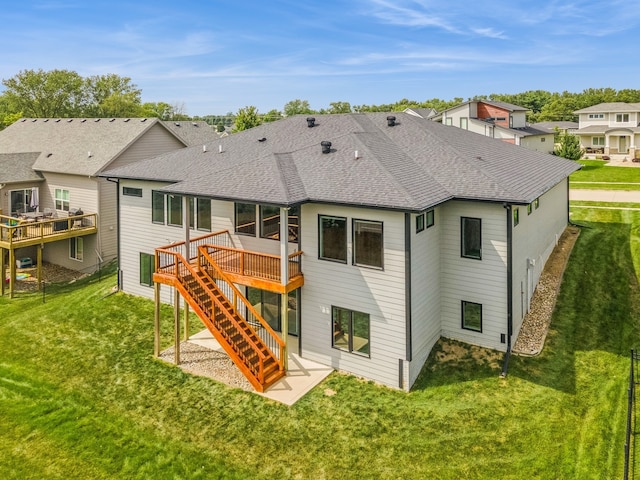 back of house with a wooden deck and a yard