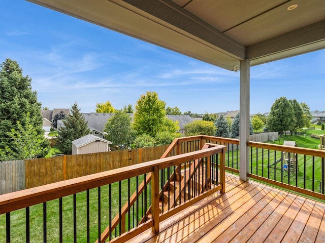 wooden terrace featuring a yard