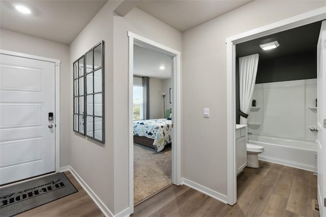 interior space with baseboards and wood finished floors