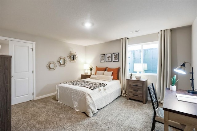 carpeted bedroom featuring visible vents and baseboards