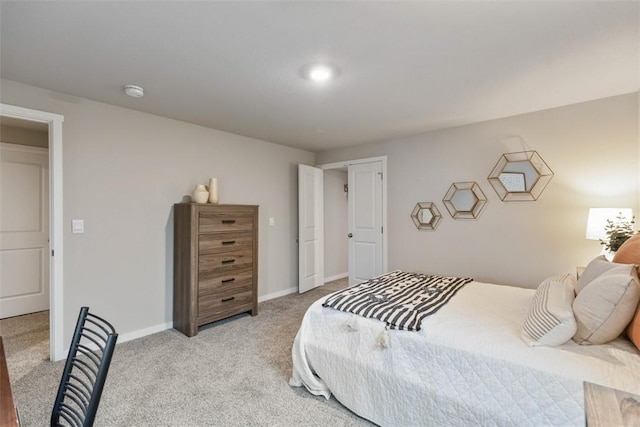 bedroom with light carpet and baseboards