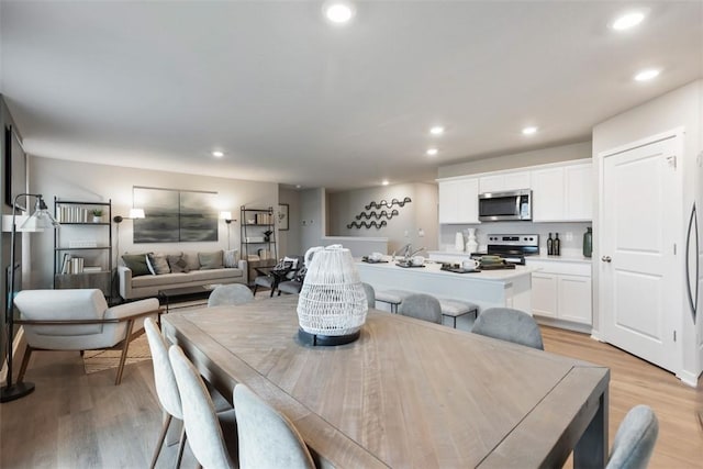 dining room featuring light wood-style floors and recessed lighting