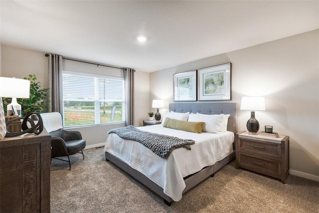 bedroom with light colored carpet and baseboards