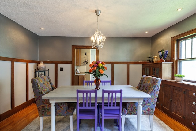 dining area featuring recessed lighting, a notable chandelier, and light wood finished floors