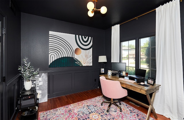 office area with an inviting chandelier and hardwood / wood-style floors