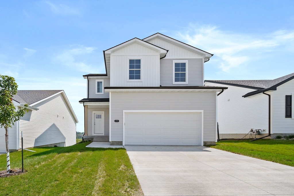 view of front of property with a garage and a front lawn