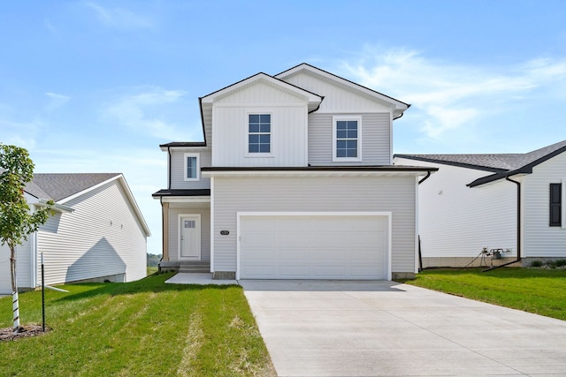 view of front of property with a garage and a front lawn