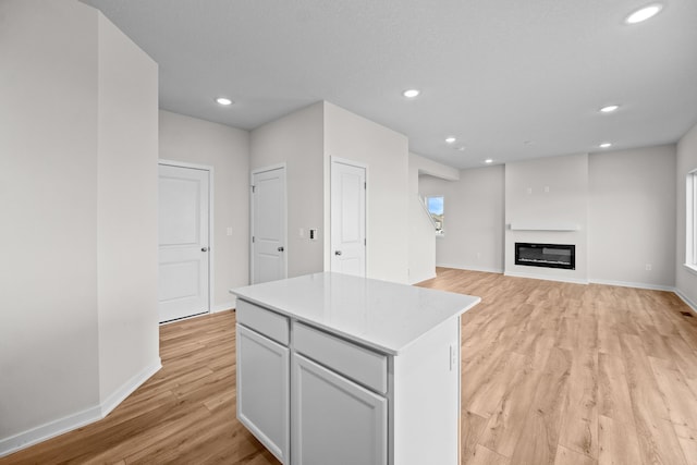 kitchen featuring light wood-type flooring, plenty of natural light, and a center island