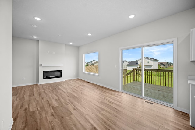 unfurnished living room featuring light wood-type flooring