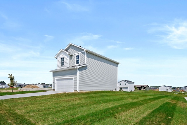 view of side of home featuring a garage and a yard