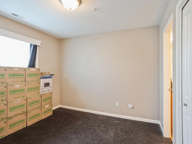 carpeted bedroom featuring visible vents, a textured ceiling, and baseboards