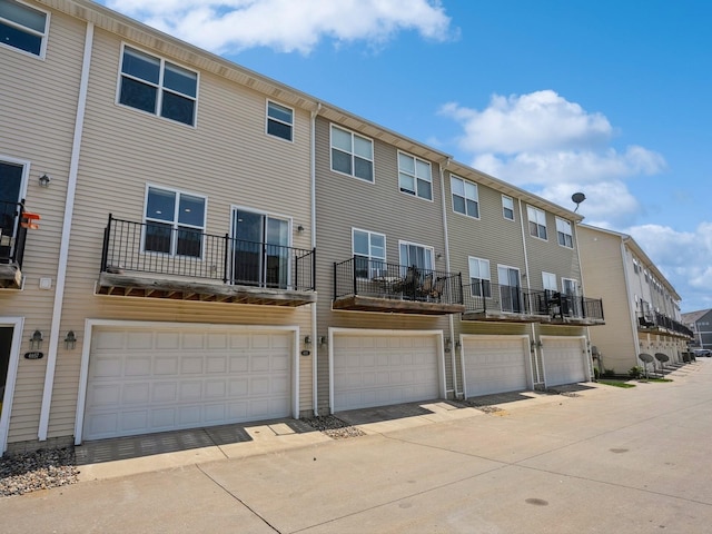 back of property featuring a residential view and a garage