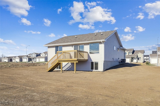 rear view of house featuring central AC and a deck