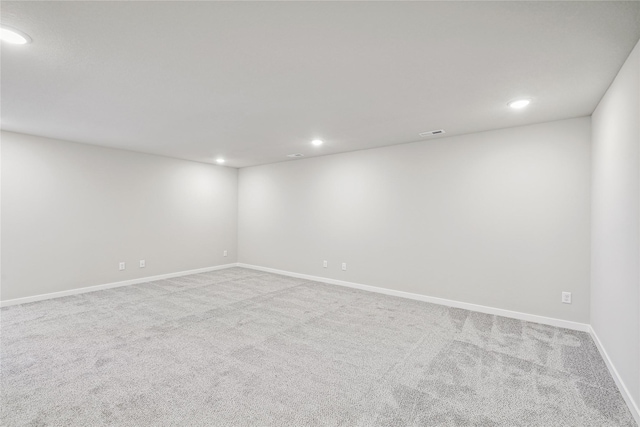 unfurnished room featuring light colored carpet