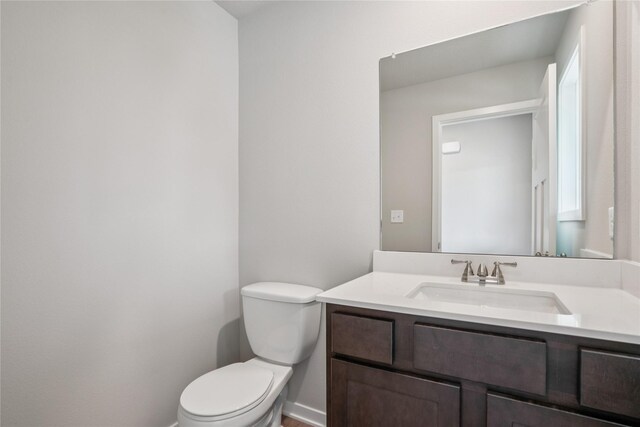 18025 Alpine Dr, Clive, IA 50325 - bathroom with toilet, vanity, and baseboards