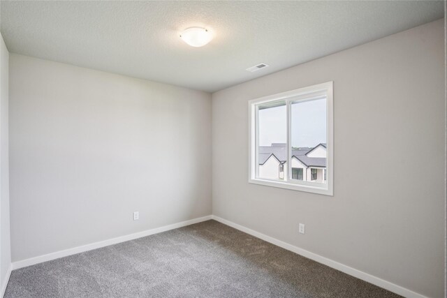 18025 Alpine Dr, Clive, IA 50325 - carpeted spare room featuring baseboards and a textured ceiling