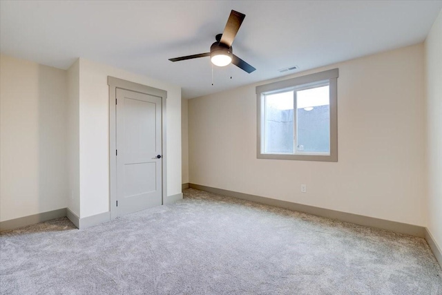 unfurnished bedroom with carpet floors, baseboards, visible vents, and a ceiling fan