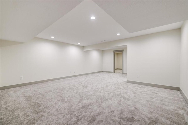 empty room featuring baseboards, light colored carpet, and recessed lighting