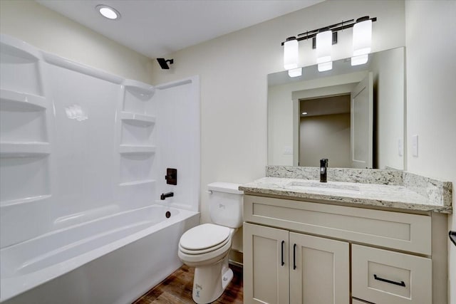 full bathroom featuring  shower combination, vanity, toilet, and wood finished floors