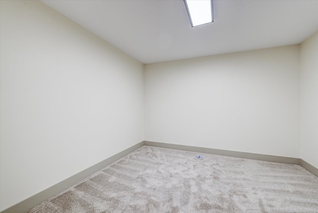 spare room featuring carpet and baseboards