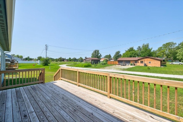 wooden deck featuring a lawn