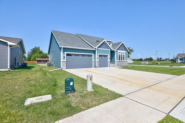 craftsman house with a front yard and a garage