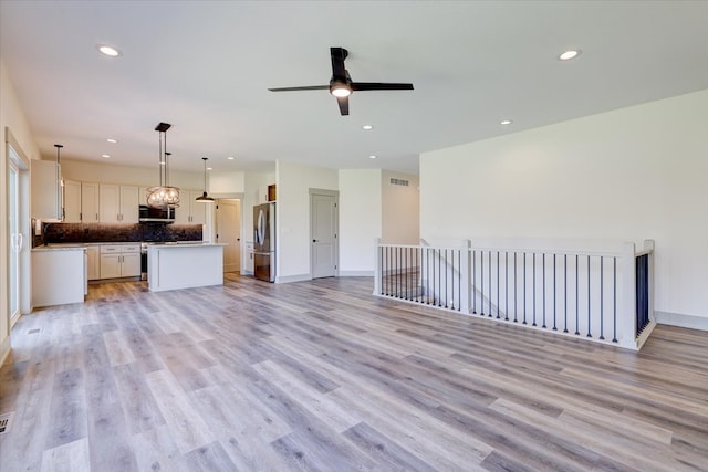 unfurnished living room featuring ceiling fan, recessed lighting, visible vents, baseboards, and light wood finished floors