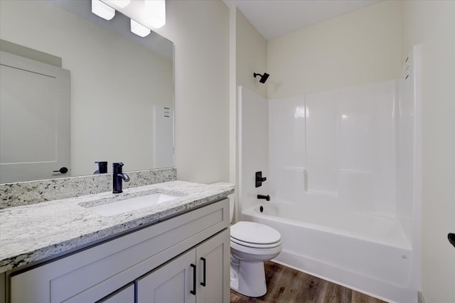 full bathroom featuring vanity, bathtub / shower combination, wood finished floors, and toilet