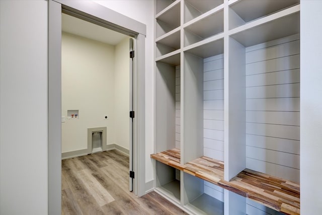 mudroom featuring baseboards and wood finished floors