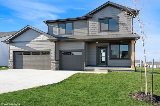 view of front of home featuring a garage and a front yard