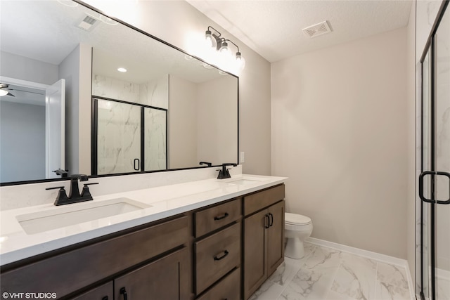 bathroom with walk in shower, a textured ceiling, vanity, ceiling fan, and toilet