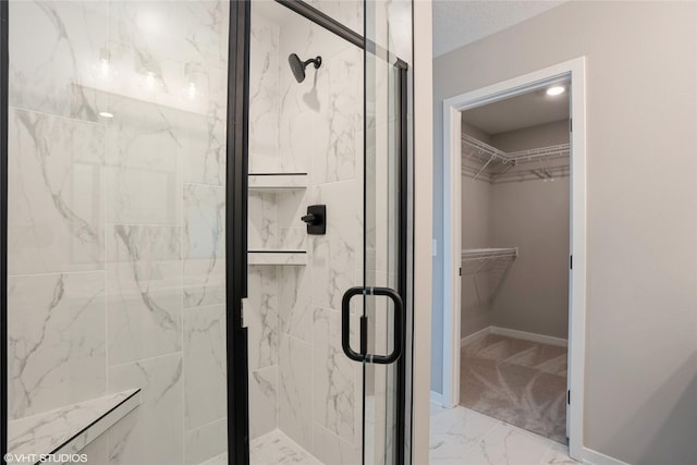 2750 SE Florence Dr, Waukee, IA 50263 - full bath featuring marble finish floors, a spacious closet, a marble finish shower, and baseboards