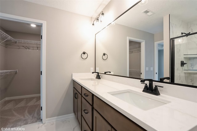 bathroom with vanity and a shower with door