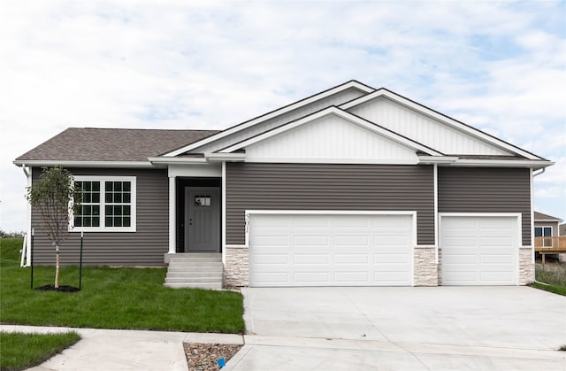 view of front of house with a front yard and a garage