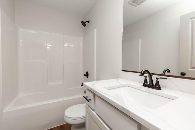 bathroom with visible vents, bathing tub / shower combination, vanity, and toilet