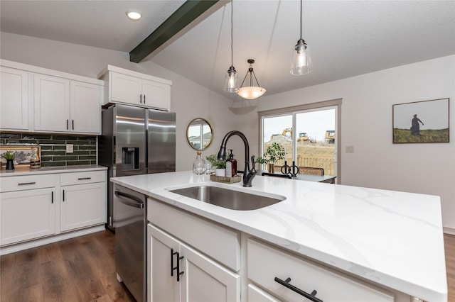 kitchen featuring vaulted ceiling with beams, a sink, appliances with stainless steel finishes, decorative backsplash, and dark wood finished floors