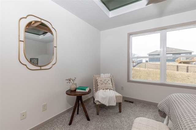 living area featuring carpet flooring, visible vents, baseboards, and a textured ceiling