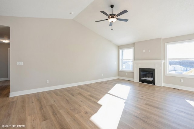 unfurnished living room with light hardwood / wood-style floors, vaulted ceiling, and ceiling fan