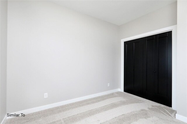 unfurnished bedroom featuring a closet and carpet flooring