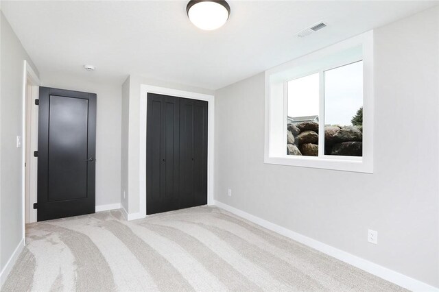 carpeted bedroom with a closet